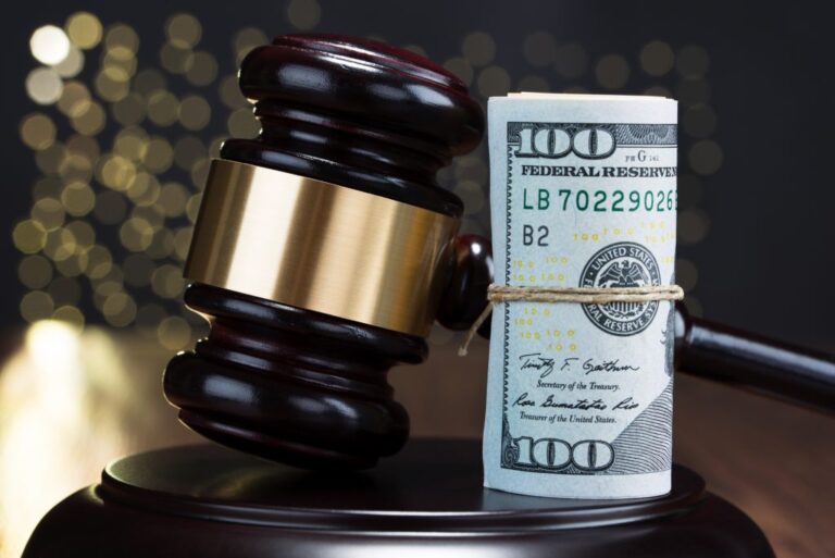 A gavel and dollar notes depicting the fee of hiring a personal injury lawyer in Indianapolis