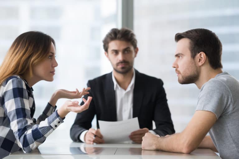 Couple arguing about divorce settlement in front of a lawyer in Indiana